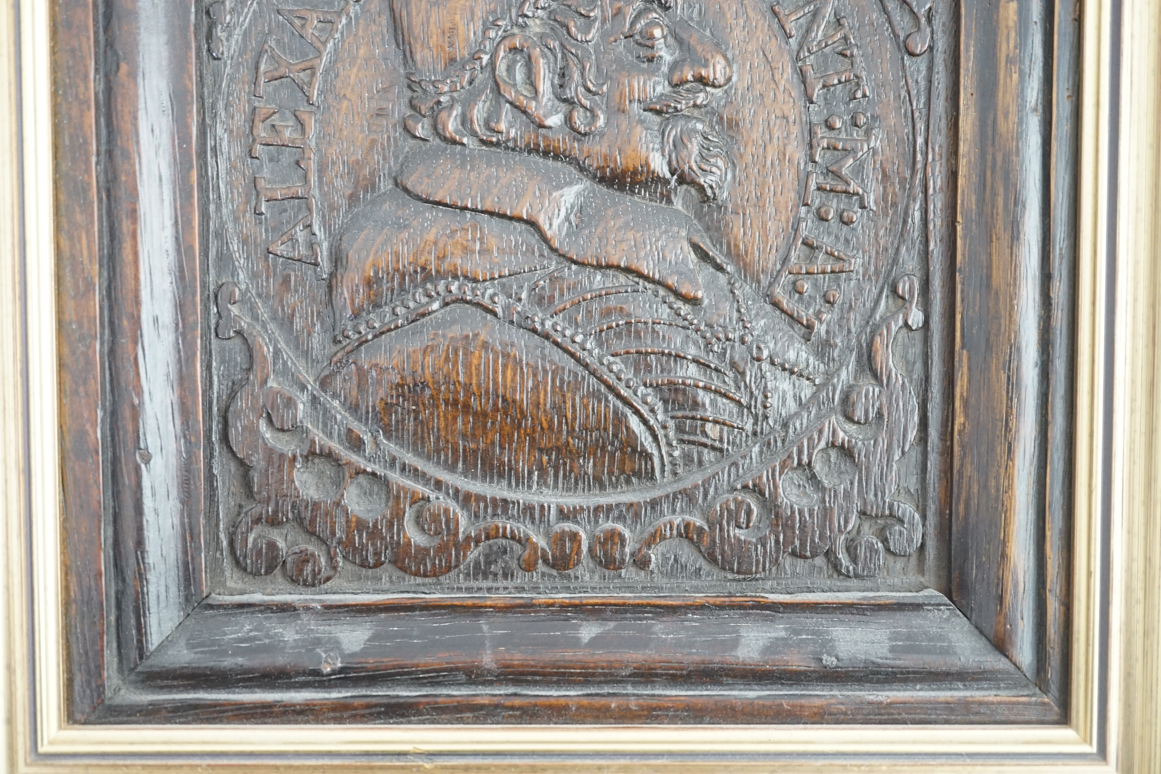 A 17th century oak panel carved with a relief portrait of Pope Alexander VII